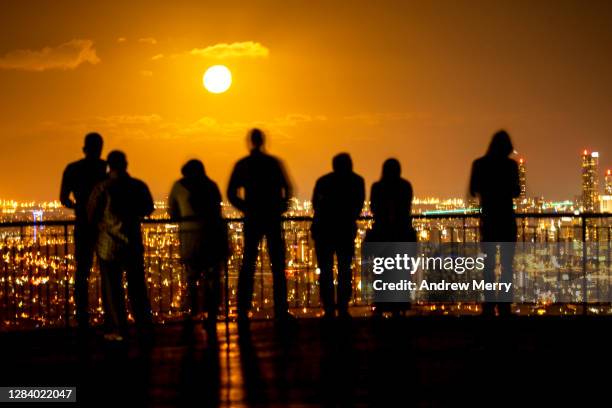 climate change, people looking at city at night - climate change people stock pictures, royalty-free photos & images