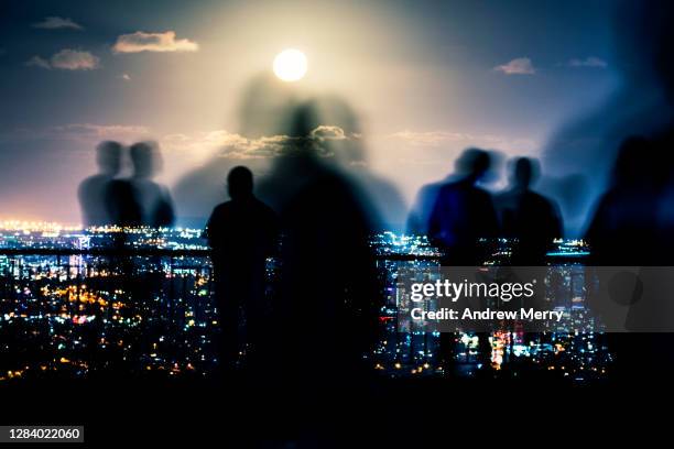 crowd of people, blurred motion, city lights and supermoon - australia technology stock-fotos und bilder