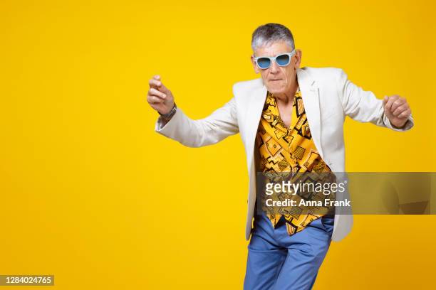 youthful old man in the sixties having fun and dancing - cool attitude stock pictures, royalty-free photos & images