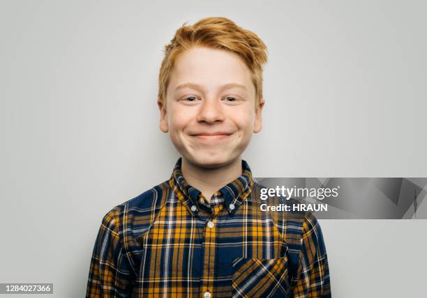 glimlachende jongen in toevalligheden tegen witte achtergrond - childs pose stockfoto's en -beelden