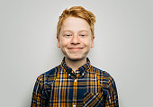 Smiling boy in casuals against white background