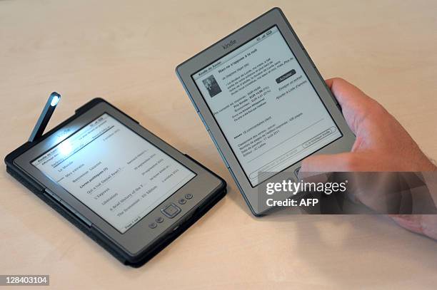 Person uses, on October 5, 2011 at Amazon France headquarters in Paris, the US online retail giant Amazon's Kindle electronic reader released in...