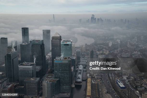 Fog shrouds the Canary Wharf business district including global financial institutions Citigroup Inc., State Street Corp., Barclays Plc, HSBC...