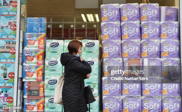 Lady is seen walking past a shop window full of toilet rolls as England enters a second national coronavirus lockdown today on November 05, 2020 in...