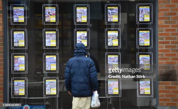 Man is seen looking at houses for sale at Butter Jon Bee's estate agents on November 05, 2020 in Stoke-on-Trent, Staffordshire, England.