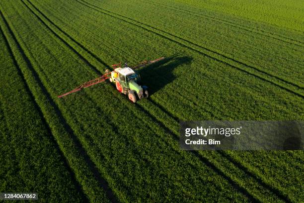 landwirtschaftliches traktorspritzfeld - landwirtschaftsgeräte ansicht von oben stock-fotos und bilder