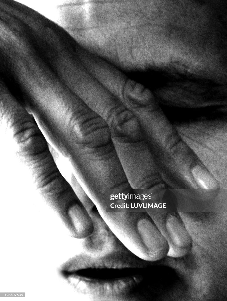 Full frame close-up of man covering his eyes