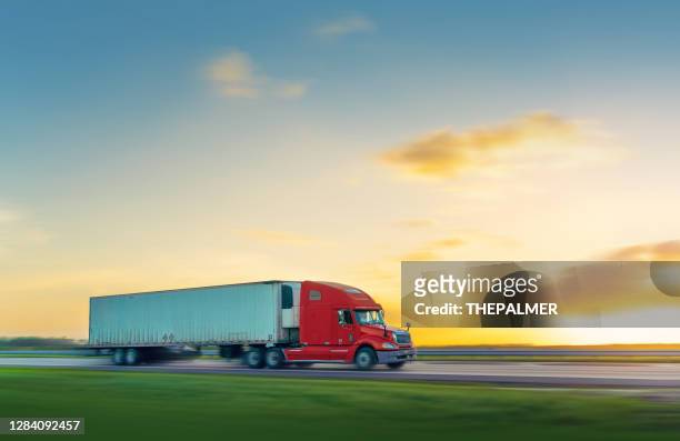 red and white semi-truck moving on a florida country road - semi truck stock pictures, royalty-free photos & images
