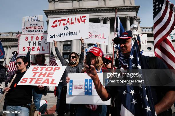 Dozens of people calling for stopping the vote count in Pennsylvania due to alleged fraud against President Donald Trump gather on the steps of the...