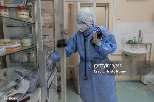 Doctor Mariyana Chatalova is seen wearing protective equipment and searching for mediaction before entering a coronavirus patients room in the ICU of...