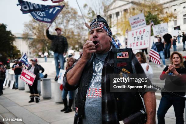 Dozens of people calling for stopping the vote count in Pennsylvania due to alleged fraud against President Donald Trump gather on the steps of the...