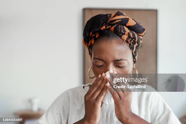 just can't shake the sniffles - sick woman blowing nose stock pictures, royalty-free photos & images