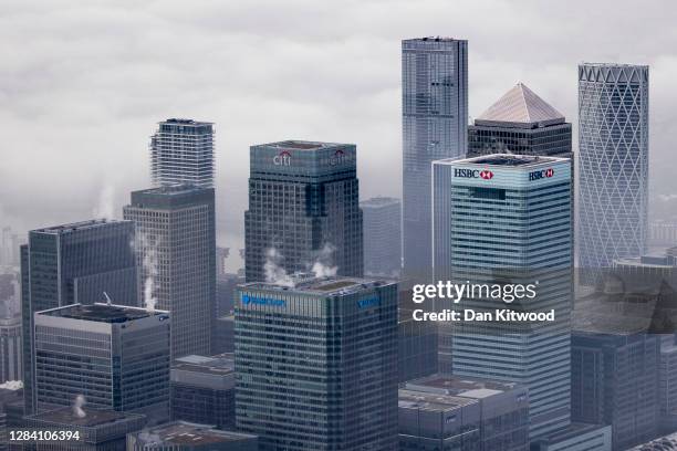 Fog shrouds the Canary Wharf business district including global financial institutions Citigroup Inc., State Street Corp., Barclays Plc, HSBC...