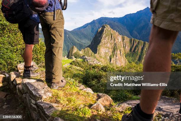 Tourists sightseeing at Machu Picchu Inca Ruins, Cusco Region, Peru, South America.