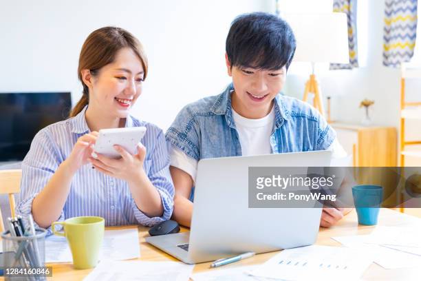 couple discuss finances at home - married money stock pictures, royalty-free photos & images