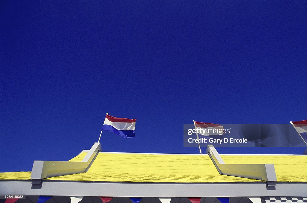 Top edge of roof with flags of fast food stand