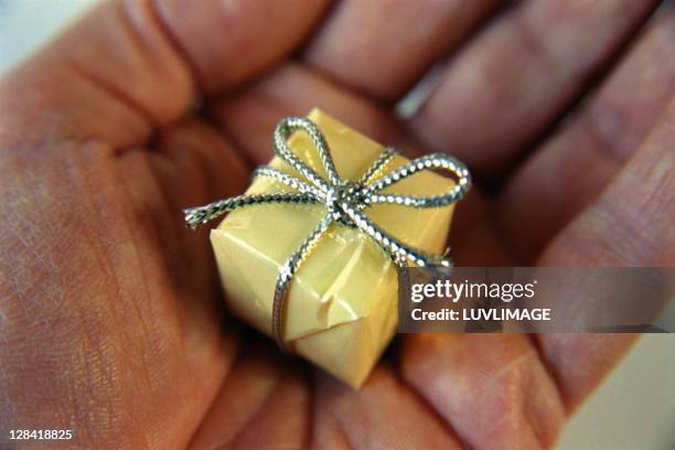 tiny present in a mans palm - small gift stock pictures, royalty-free photos & images
