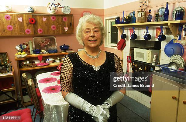 lady dressed as queen mother in suburban kitchen - funny royalty stock pictures, royalty-free photos & images