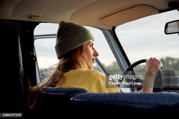 young woman sitting in the car while watching the sundown. - platinum rings stock pictures, royalty-free photos & images