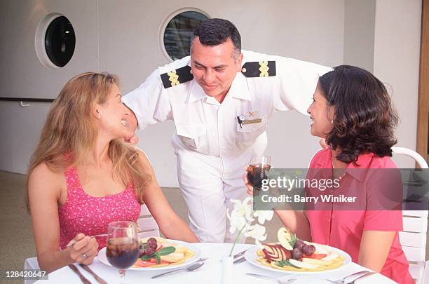 passengers talk w/ food and; beverage manager - cruise liner foto e immagini stock