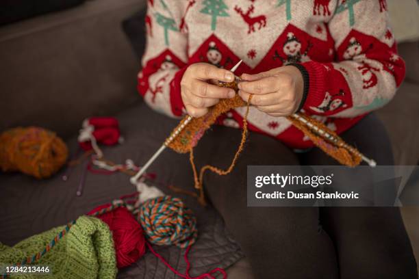 an old woman in sweater is knitting - christmas jumper stock pictures, royalty-free photos & images
