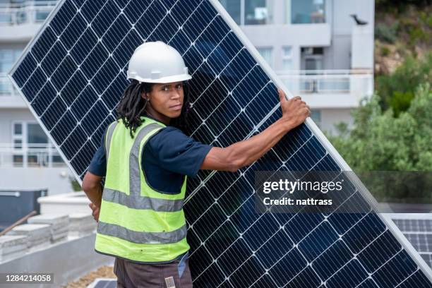 african man installing solar panels - solar panel installation stock pictures, royalty-free photos & images
