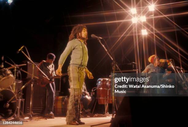Bob Marley performing on stage with The Wailers at the West Coast Rock Show, Ninian Park in Cardiff, Wales, 19th June 1976. L-R Donald Kinsey , Bob...