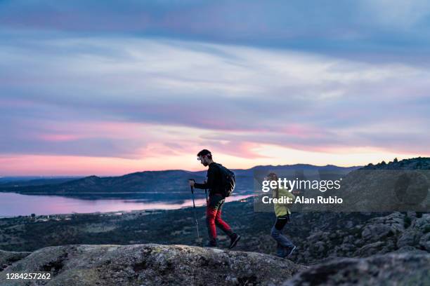 young couple of adventurers doing a night trekking route. - color intensity stock-fotos und bilder