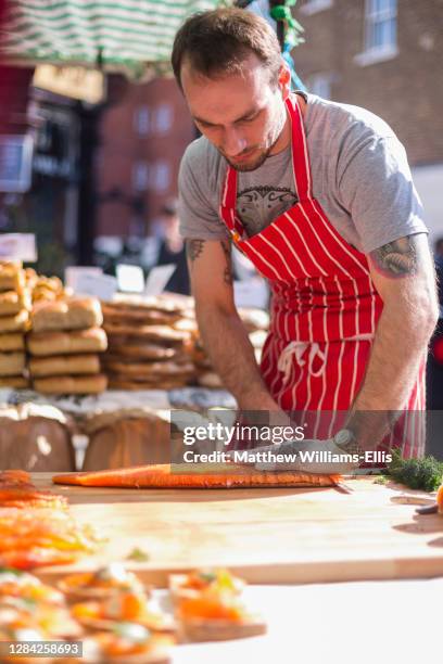 Smoked salmon being served at Broadway Market, Hackney, London, England.