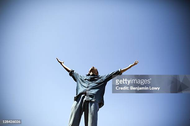 Libyan man screams and raises his hands in joy and happiness, while visiting the Bab al-Aziziya, the home of former Libyan dictator Moammar Gaddafi...