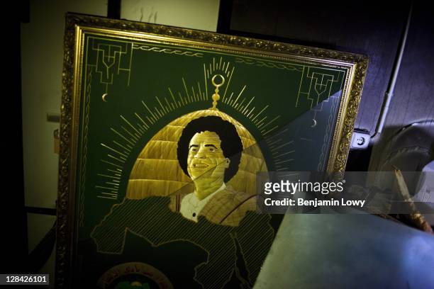 An engraving of a young Moammar Gaddafi is found stored in a catacomb of tunnles underneth the former Libyan dictators home on August 29 2011 in...