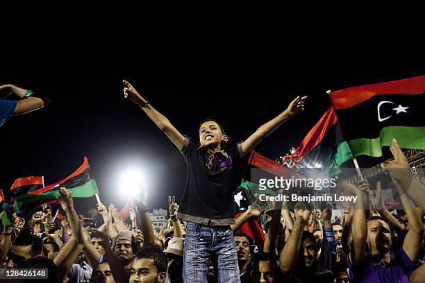 Libyans celebrate the fall of Libyan dictator Moammar Gaddafi in the the newly renamed Martyr's Square on August 30 2011 in Tripoli, Libya.