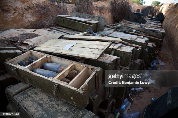 Stash of 120mm Mortars and other live ordinance lie abandoned in a trench near the bombed out remains of a Libyan Government weapons depot located on...