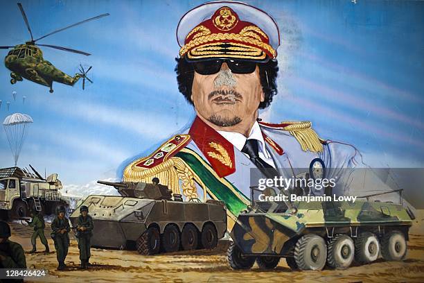 Mural depicting a victorious battle of the Libyan military forces against a vague enemy lies on the infamous Khamis Brigade headquarters parade...