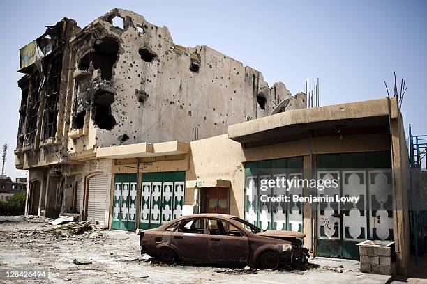 War ravaged buildings pockmarked with mortar and bullet holes, are abandoned on Tripoli street on September 3 2011 in Misrata, Libya.