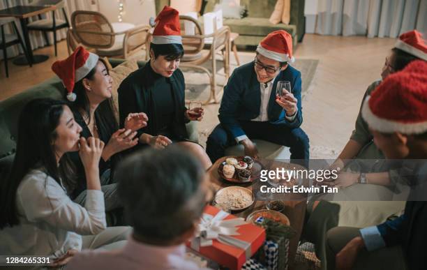 asian chinese office colleague social gathering celebrating christmas party after working hour in office lounge - political party stock pictures, royalty-free photos & images