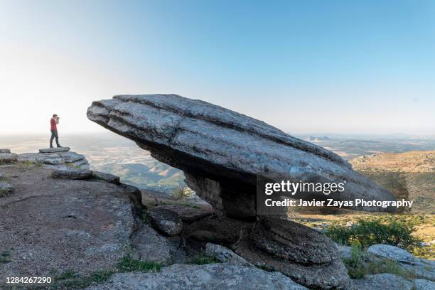 man taking pictures in el torcal de antequera mountain range - paraje natural torcal de antequera stock pictures, royalty-free photos & images