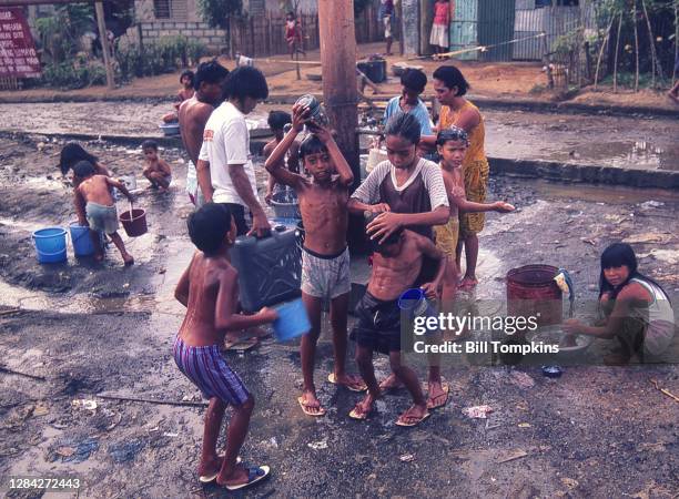 July 1988]: MANDATORY CREDIT Bill Tompkins/Getty Images Children's Wash Station. The Payatas Dumpsite, a 13 hectare garbage dumpsite. The site houses...