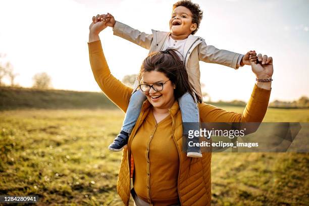 happy together - piggyback stock pictures, royalty-free photos & images