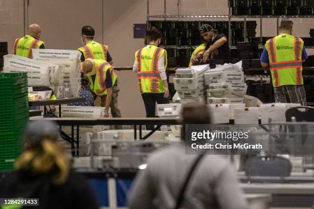 Election workers count ballots at the Philadelphia Convention Center on November 06, 2020 in Philadelphia, Pennsylvania. Joe Biden took the lead in...