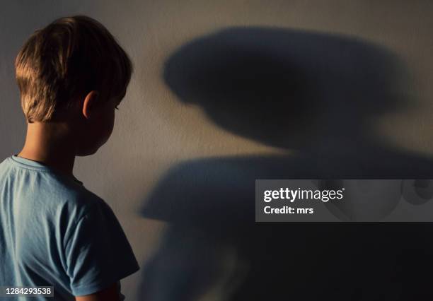 lonely boy and his shadow - child alone stockfoto's en -beelden