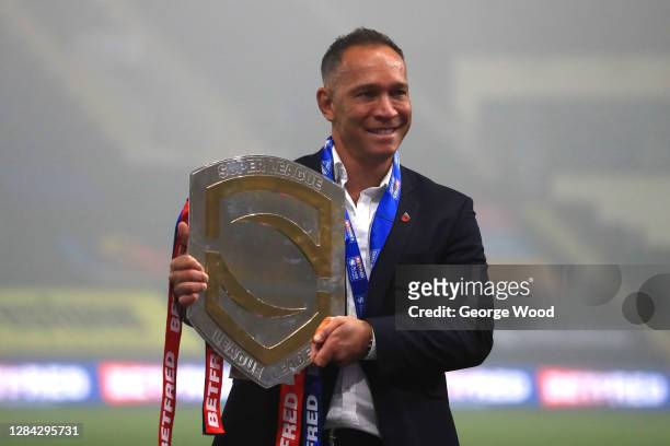 Adrian Lam, head coach of Wigan Warriors poses for a photo with the League Leaders' Shield after the Betfred Super League match between Wigan...