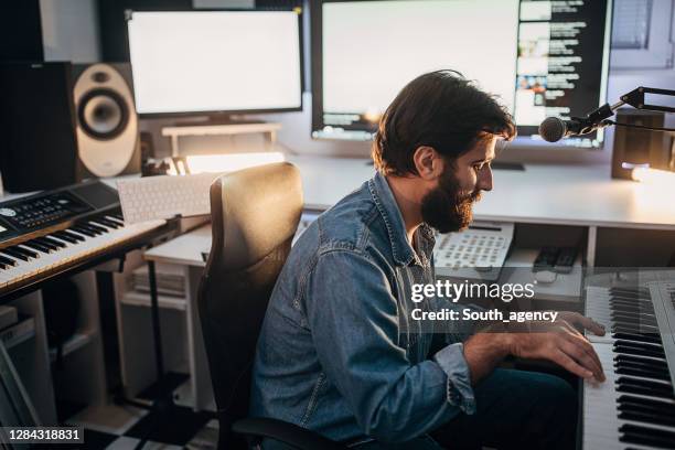 man working on a new song in music studio - music producer stock pictures, royalty-free photos & images