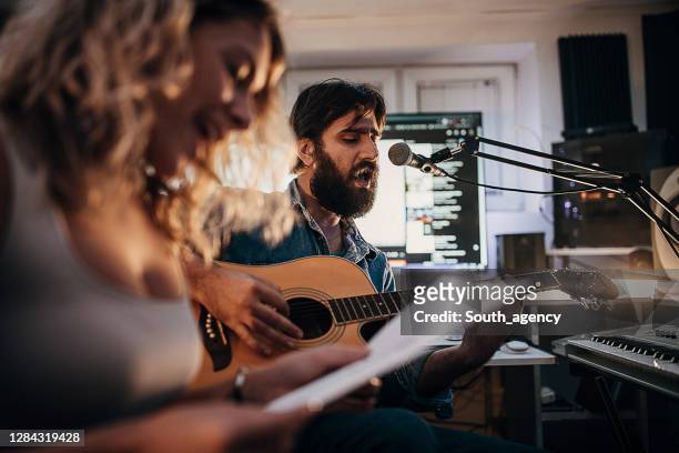 musical duo singing in studio - duet stock pictures, royalty-free photos & images