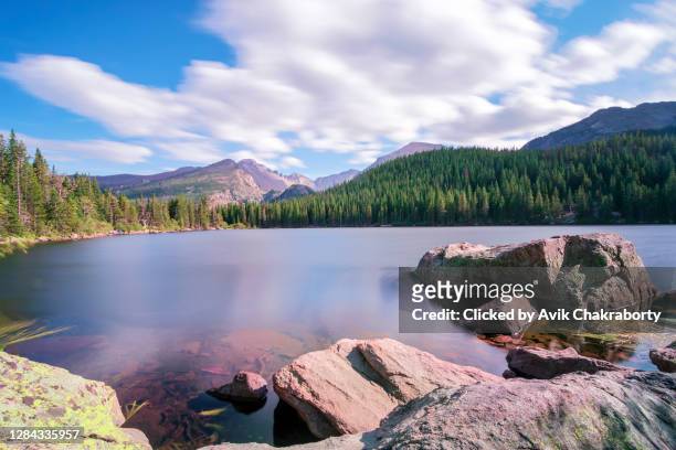 floating clouds over bear lake in rocky mountains national park colorado - rocky mountain national park ストックフォトと画像