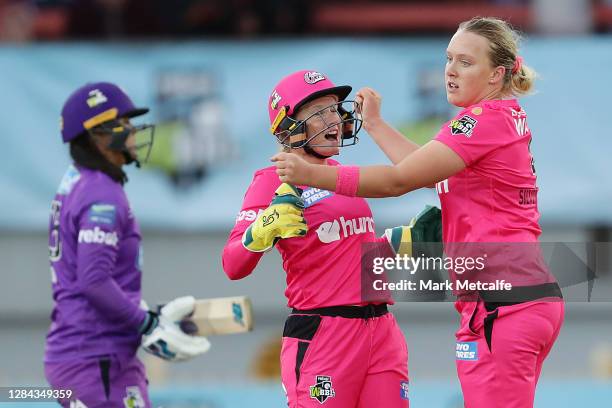 Hayley Silver-Holmes of the Sixers celebrates with team mate Alyssa Healy after taking the wicket of Chloe Tryon of the Hurricanes during the Women's...