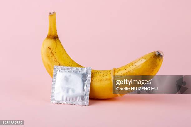 condom and yellow banana - condom stock pictures, royalty-free photos & images