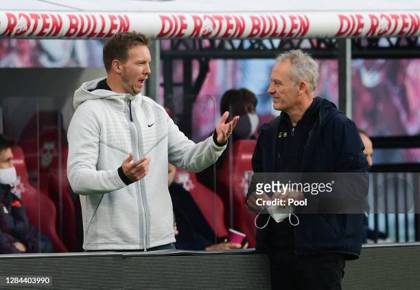 Head coaches Julian Nagelsmann of Leipzig and Christian Streich of Freiburg chat prior to the Bundesliga match between RB Leipzig and Sport-Club...