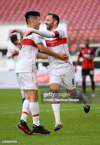 Gonzalo Castro of VfB Stuttgart celebrates with teammate Wataru Endo after scoring his team's second goal during the Bundesliga match between VfB...