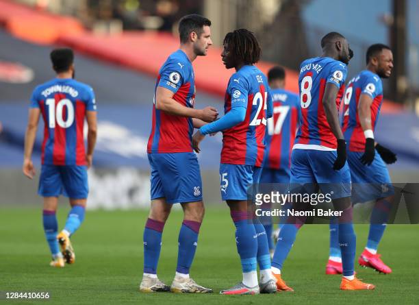 Scott Dann of Crystal Palace celebrates with teammate Eberechi Eze after scoring his team's first goal during the Premier League match between...